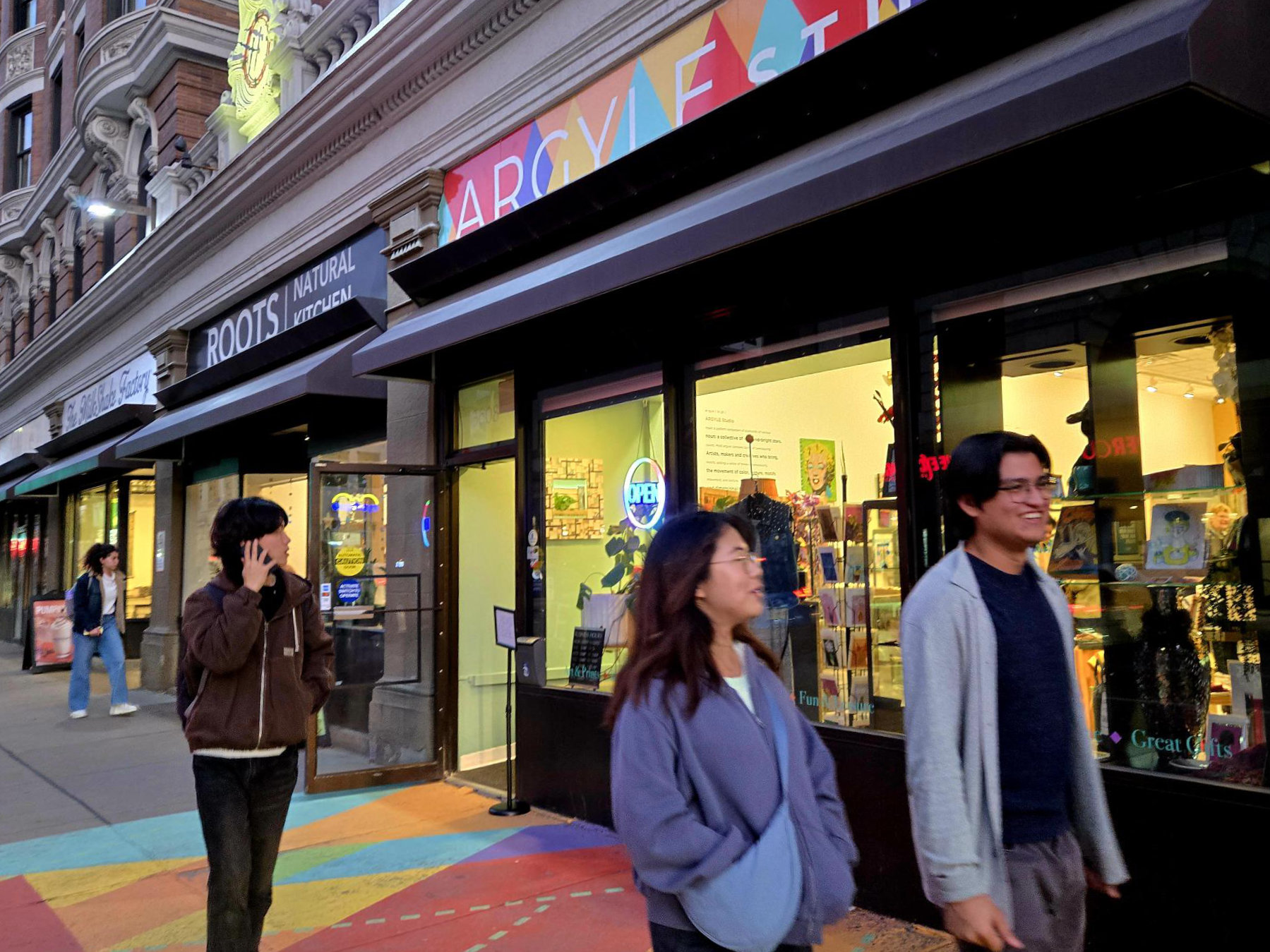 Pedestrians passing the Argyle Studio storefront in Oakland