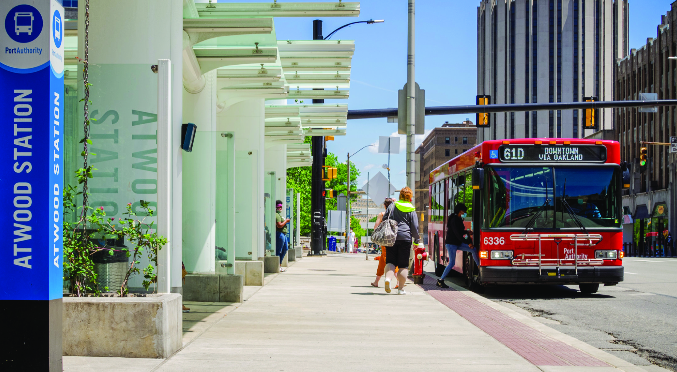 Riders boarding a bus at Atwood Station in Oakland