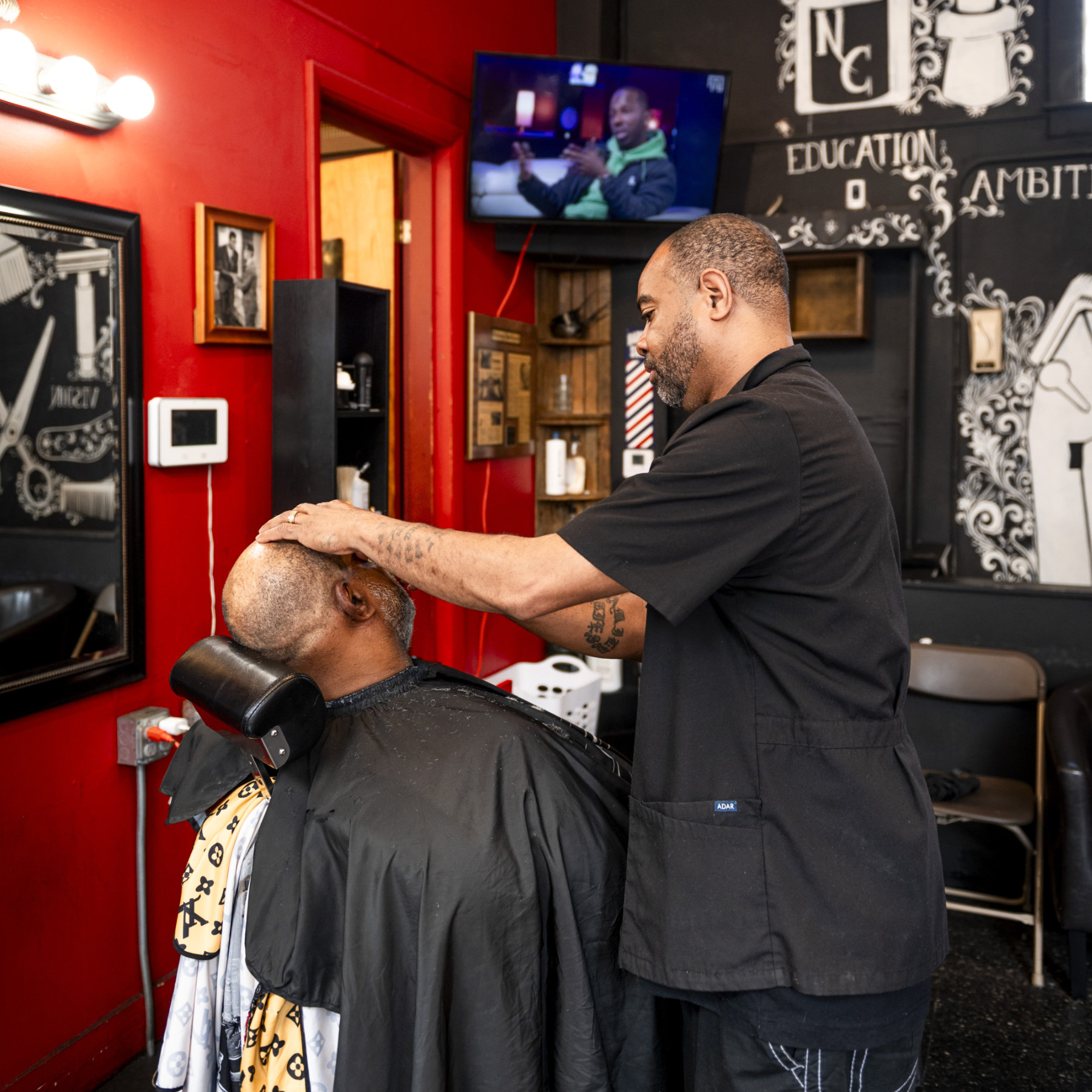 Barber at work in an Oakland barbershop